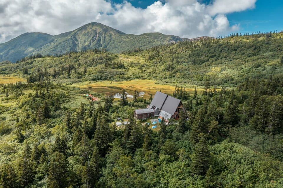 Mt Hiuchi in summer seen from a drone with the Koya pond and mountain hut in view in front of Mt hiuchi.