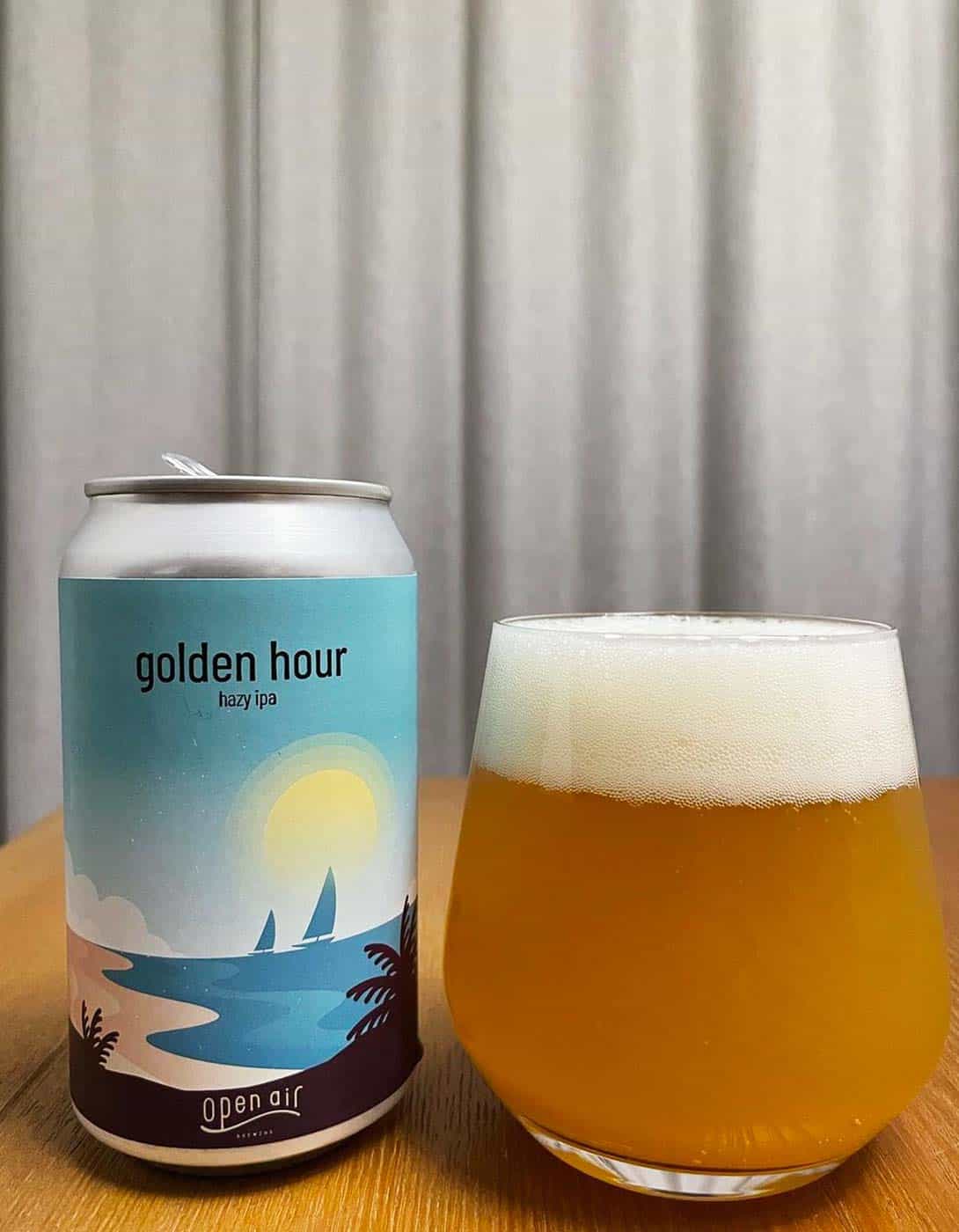 Golden hour hazy IPA beer can and beer in a glass.